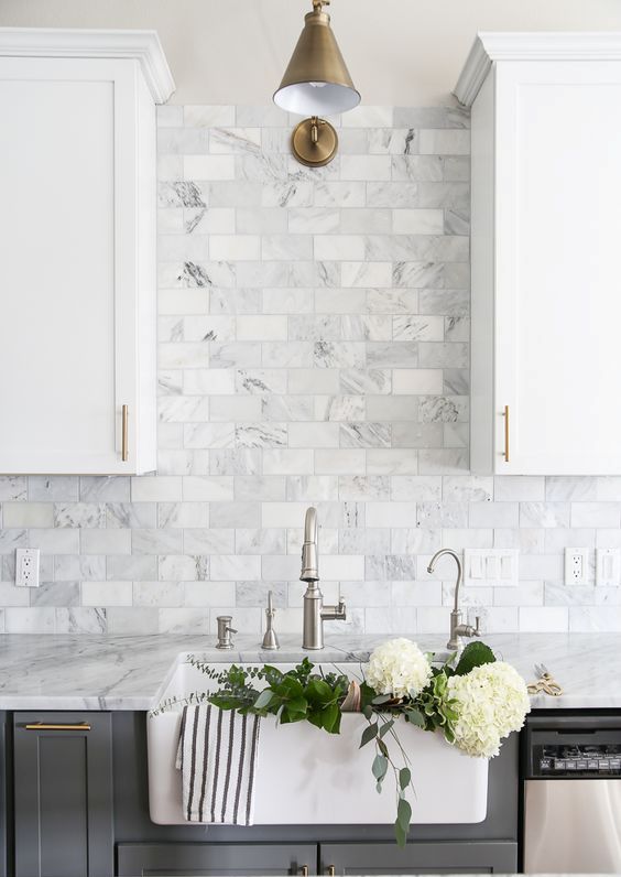 grey marble subway tiles are ideal for a two-toned grey and white kitchen and add a refined feel to it