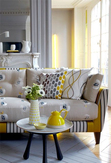 a creative sofa with applie printed and striped upholstery on the frame that match in colors