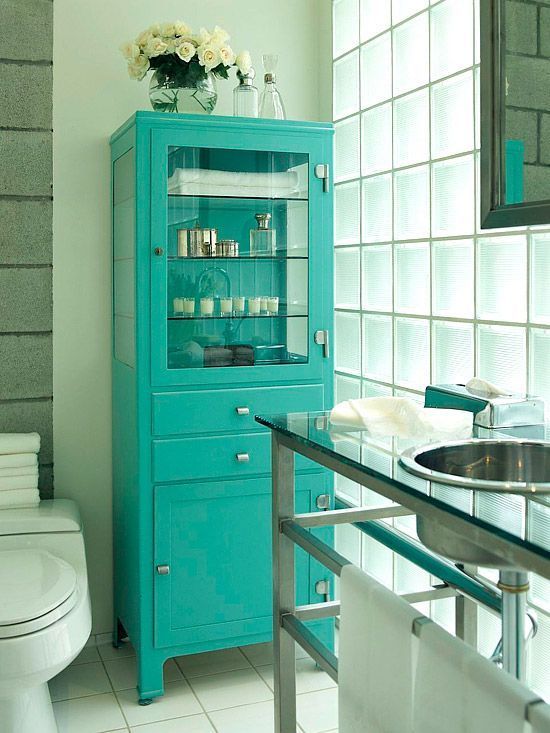 An old fahsioned pharmacy cabinet redone with a bold color   turquoise, gets a new life and a fresh feel