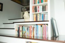 25 bookshelves built-in right into the staircase to use every inch of space