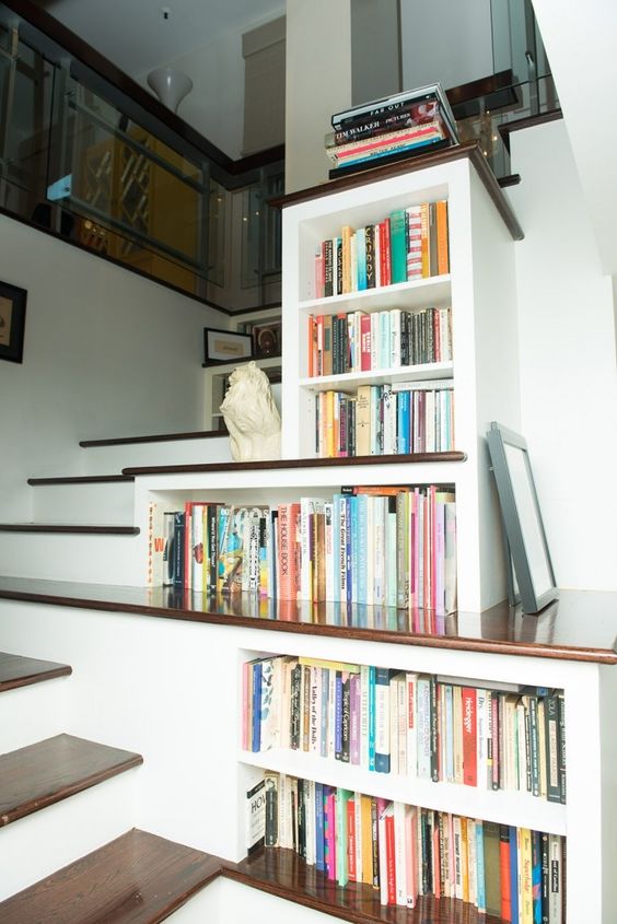 bookshelves built-in right into the staircase to use every inch of space
