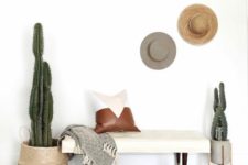 26 an upholstered bench, a couple of hats, cacti in pots and a leather pillow are all you need