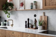 26 rich-colored wooden cabinets with grey marble tiles for the backsplash and countertops