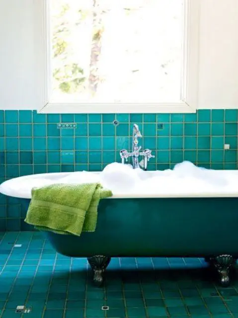 Turquoise tiles and a matching bathtub for a bold vintage inspired space