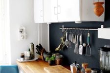 27 a cozy small white kitchen with a light-colored countertop and a chalkboard backsplash that adds style