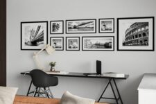 a Scandinavian living room with a black trestle desk, an amber leather low sofa, grey pillows, a gallery wall