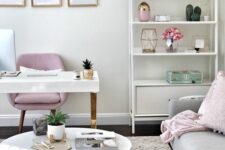 a lovely living room with a white desk, a pink chair, some decor, a storage unit with decor, a grey sofa and pillows, a coffee table