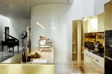 01 The kitchen has a strong wow factor, it’s done with brass, marble and concrete, it shines from a distance