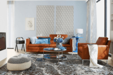 01 The living room is done with rust-colored leather furniture and blue accents