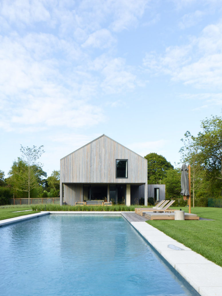 There's a large pool in the backyard plus a deck, and the house is clad with natural wood