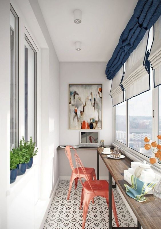 a balcony breakfast bar with a windowsill and a couple of coral painted metal chairs