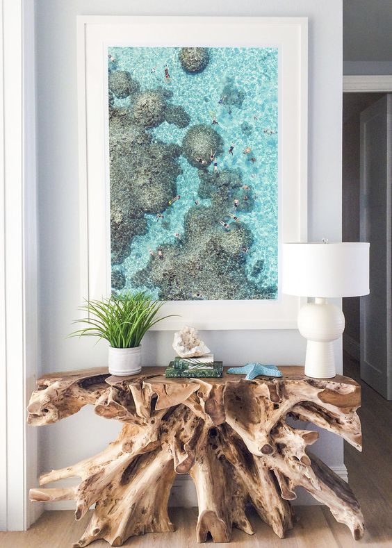 a unique raw edge wood console, a turquoise star fish and an oversized photo from a holiday for a wow effect