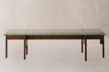 03 The dining table is made of dark stained wood and features a glass top