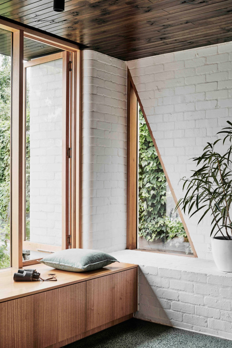 There's a large window and a couple of triangle cutouts for connecting the space to outdoors and fill it with natural light