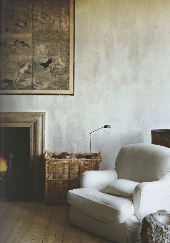 a neutral cozy space with greyish plaster walls that add more texture to the space