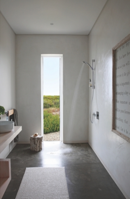 The bathroom features a view, a shower that feels like outdoors and some wooden furniture