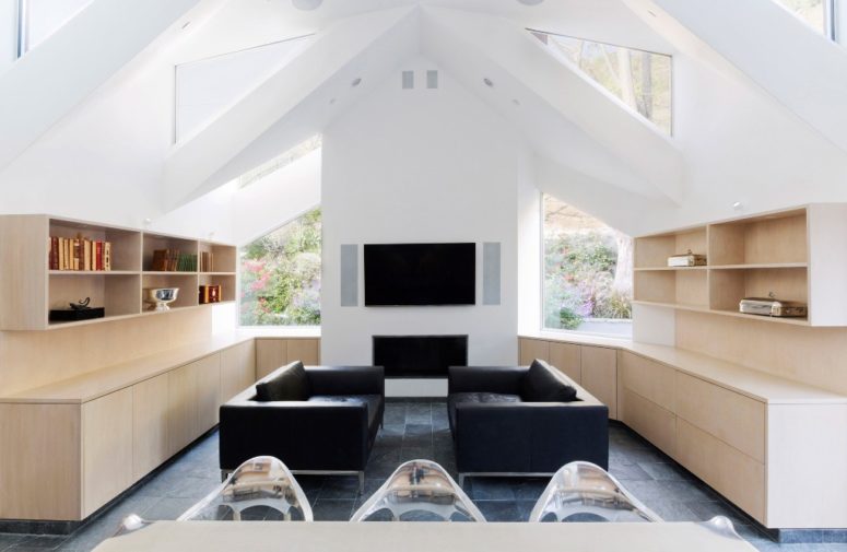 This is a sitting zone with two sofas, shelves and a built-in fireplace