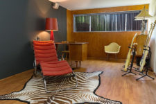 05 The home office is done in graphite grey and with plywood, with red touches and a faux zebra skin rug