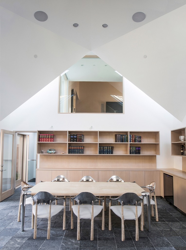 This is a conference zone with bookshelves and a table that can accommodate up to 8 people