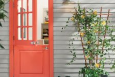 05 a bright space with a red Dutch door, a planter with a trellis and green rubber boots for a rustic feel