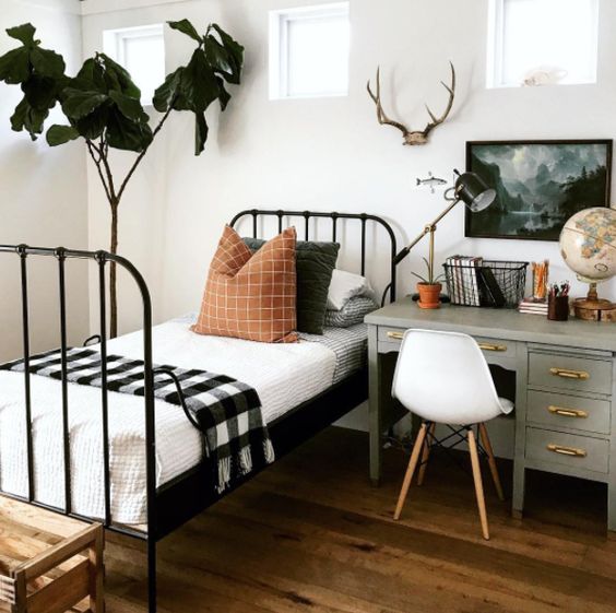 A woodland inspired guest bedroom with a desk by the bed to use it as a nightstand too