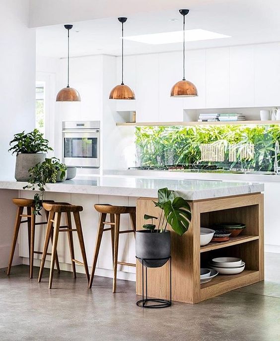 continue the outdoor greenery decor with indoor plants to tie the kitchen to outdoors