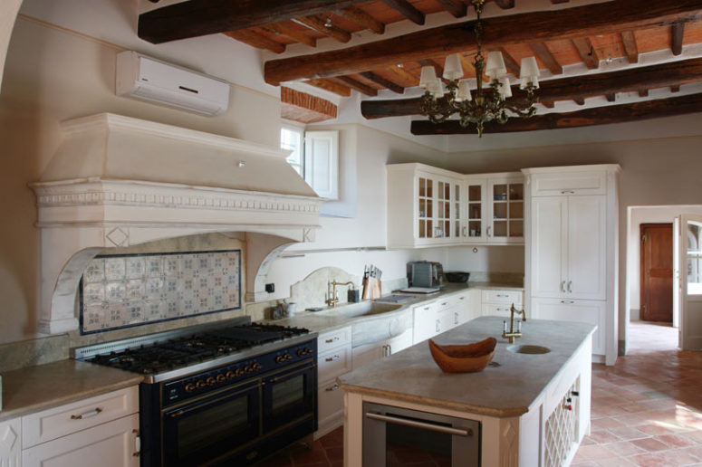 The kitchen is large, with white vintage cabinets and a kitchen island
