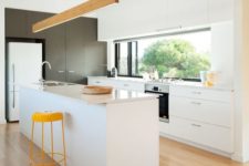 06 a contemporary white kitchen with touches of yellow and wood plus a window backsplash