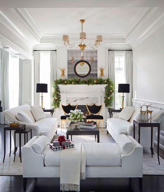 a gorgeous living room with a luxurious feel, two white sofas contrast two black chairs next to them