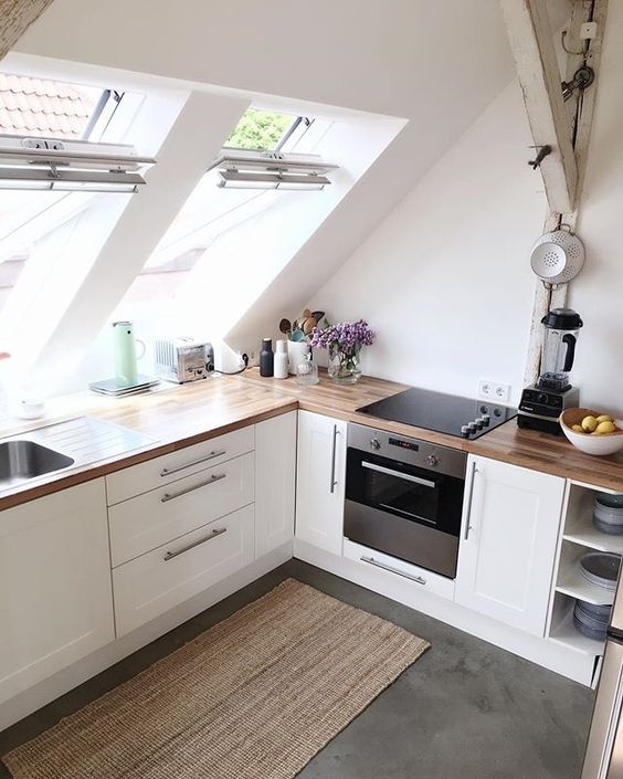 Kitchen cabinets built in under the attic skylights to fill the cooking space with light