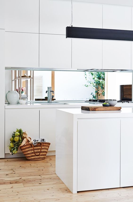 a contemporary white kitchen with sleek cabinets allows seeing the inner courtyard