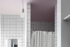 08 The bathroom is done with a pink ceiling and white tiles with black grout for a creative look