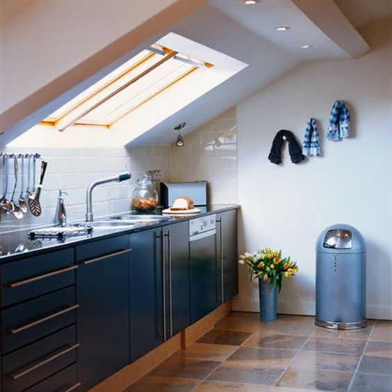a contemporary space with a skylight and additional lights and cabinets fitted under the skylight