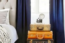 vintage suitcases stacked as a bedside table