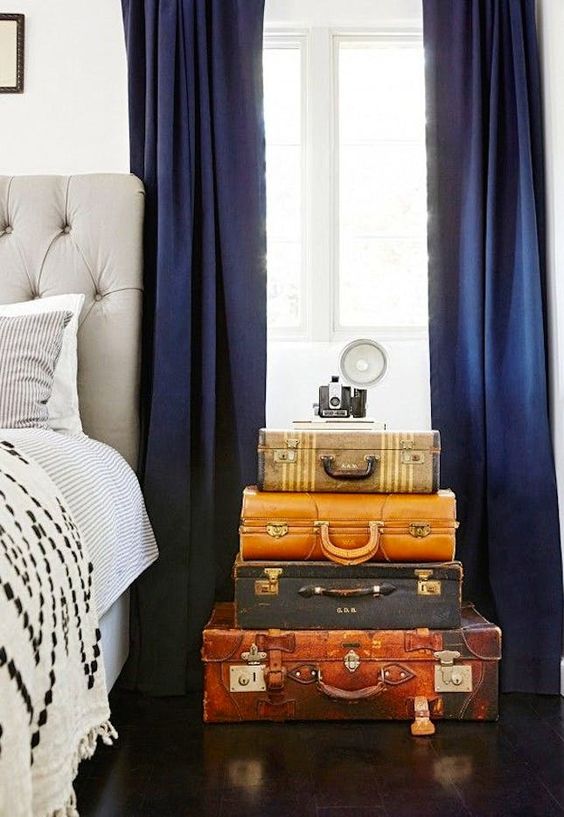 a stack of vintage suitcases adds color and interest to the bedroom making it more special