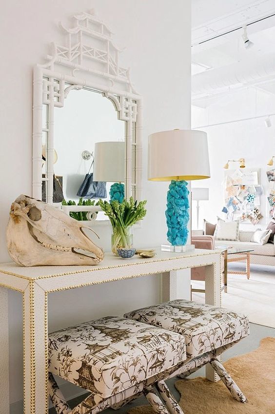 a hammered console, a skull, greenery and a creative blue rock lamp for a bright touch