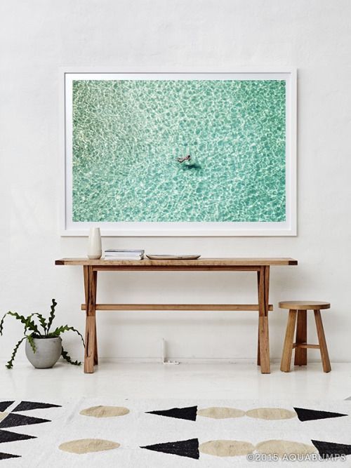 a rustic console table with an oversized water artwork is all you need for a modern look