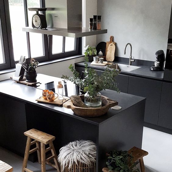 Grey plaster wall with black sleek cabinets for an ultra modern Scandinavian kitchen