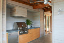 cool outdoor kitchen that features reclaimed wood