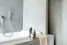 10 grey plaster walls and covered bathtub for a minimalist space