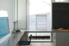 11 The home office is done with a corner desk and large windows to enjoy the courtyard views
