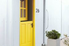 11 a creative entrance with a bright yellow Dutch door and a fun pritned rug