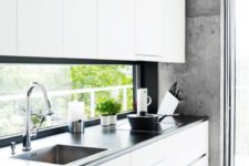 11 a minimalist white kitchen with a black framed window backsplash for a more catch and peaceful look