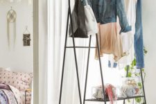 11 an airy yet stable metal coat rack with clothes and shoes doesn’t look bulky