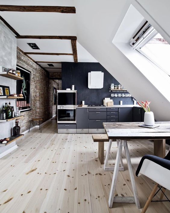 a Scandinavian black and white space with lots of skylights that bring light in and much wood for coziness