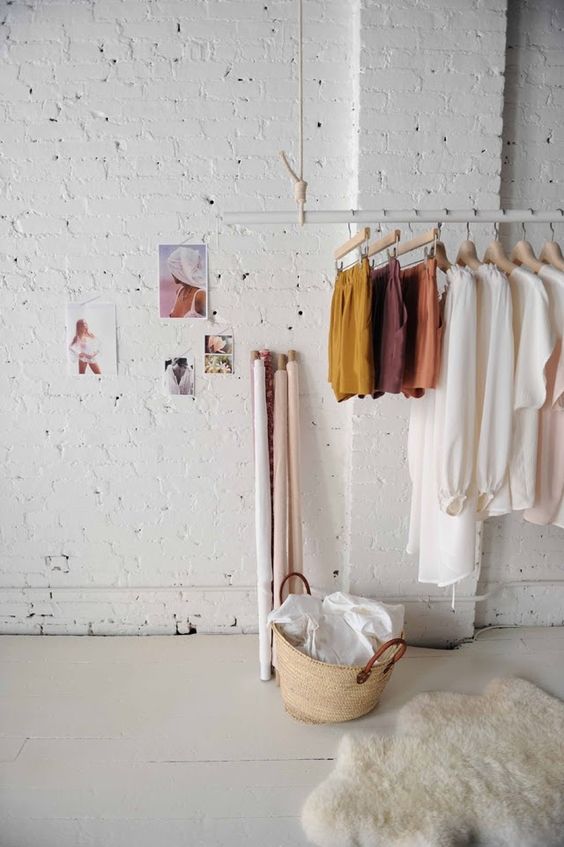 an ethereal girlish space with a hanging rack of rope and a tube for an airy look