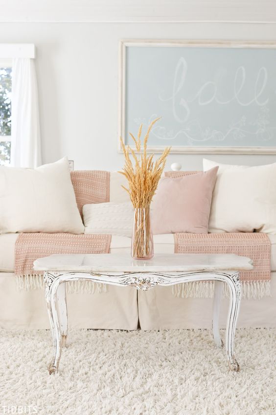 a chic living room with touches of blush and powder blue for a touch of color