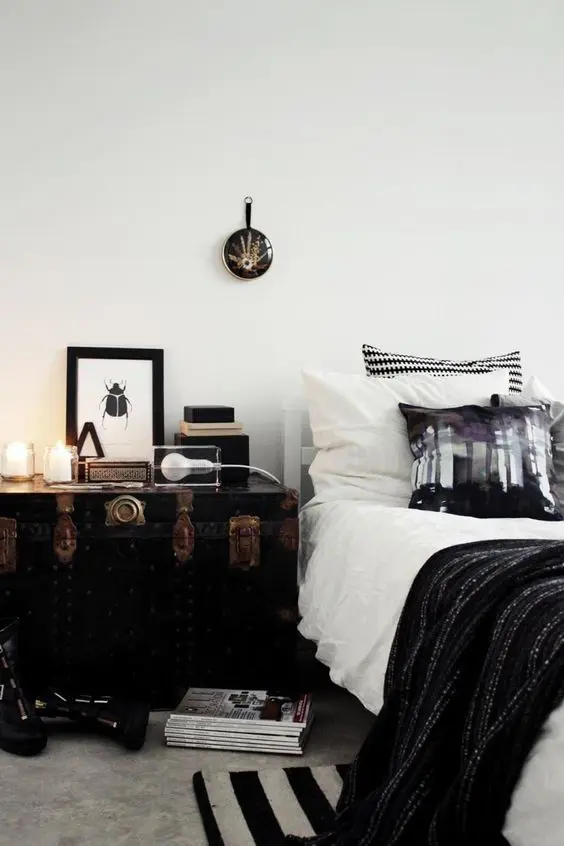 a large vintage chest painted black brings a unique personalized touch to the bedroom