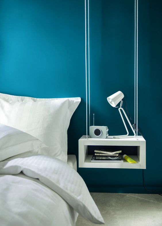 a hanging modern bedside table of a box features open storage and a laconic look