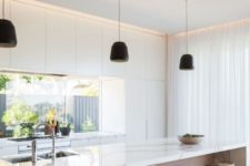 14 a white minimalist kitchen with wooden touches and a window backsplash for much light in the space